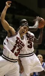 Martin Zeno snags a rebound past teammate Decensae White during the first half.