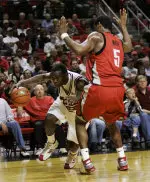 Martin Zeno (3) tries to get past UNLV guard Wendell White. (AP Photo)