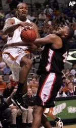 Longhorns' P. J. Tucker and Darryl Dora collide during the first half.
