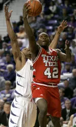 Charlie Burgess puts up a shot past Kansas State guard Lance Harris during the first half.