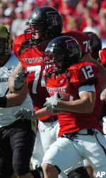 Eric Morris runs for short yardage after catching a pass in the second quarter. Blocking Colorado's Tyson DeVree on the play is Rylan Reed (74) (AP Photo/Joe Don Buckner)