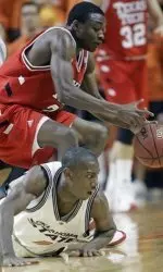 Texas Tech guard Martin Zeno, top, reaches for a lose ball as Oklahoma State guard Terrel Harris, bottom, looks on from the floor during the first half. (AP Photo/Sue Ogrocki)