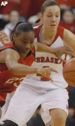 Texas Tech's Tiny Henderson (23) battles with Nebraska's Jelena Spiric (4) for a loose ball during the first half.