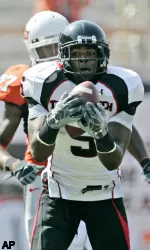 Texas Tech wide receiver Michael Crabtree pulls in a pass for a 30 yard gain against Oklahoma State in the first quarter of a college football game in Stillwater, Okla, Saturday, Sept. 22, 2007. Oklahoma State defender Calvin Mickens is at rear. (AP Photo/Sue Ogrocki)