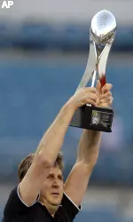 Texas Tech head coach Mike Leach holds the Gator Bowl trophy after his team beat Virginia. (AP Photo/Stephen Morton)