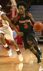 Maria Moore drives the ball downcourt while Arkansas sophomore Charity Ford defends. (AP Photo/J.T.Wampler)