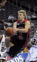 Alan Voskuil drives to the basket between Mississippi State forward Ravern Johnson and guard Barry Stewart, right, during the first half. (AP Photo/Bill Kostroun)