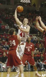 Damir Suljagic shoots for two points and draws a foul against Oklahoma's Cade Davis. (AP Photo/Lubbock Avalanche-Journal, Joe Don Buckner)