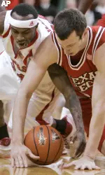 Texas Tech's Trevor Cook, right, and Nebraska's Cookie Miller go for a loose ball in the first half (AP Photo)
