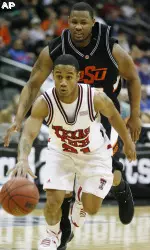Texas Tech guard John Roberson is tracked down by Oklahoma State guard Byron Eaton during the first half. (AP Photo/Ed Zurga)