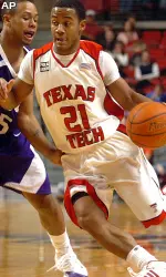John Roberson drives past TCU's Ronnie Moss during the first half.
