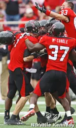 Steven Sheffield, Andre McCorkle, and Blake Kelley celebrate in the game against New Mexico.