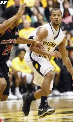 Wichita State's Clevin Hannah brings the ball up court as Texas Tech's John Roberson defends in the first half.
