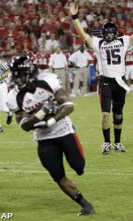 Taylor Potts signals an early touchdown as he watches running back Baron Batch run for the end zone during the first quarter.