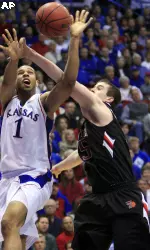 Kansas guard Xavier Henry (1) is fouled by Texas Tech forward D'walyn Roberts (5) during the first half. (AP Photo/Orlin Wagner)