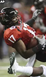 Texas Tech's Detron Lewis (17) is hit by Michigan State's Jeremy Ware after a reception during the second quarter.