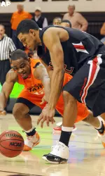 Mike Singletary and Oklahoma State's Roger Franklin scramble for a loose ball.