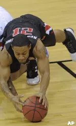 Kansas guard Sherron Collins (4) and Texas Tech guard John Roberson (21) dive for the ball during the first half. (AP Photo/Reed Hoffmann)