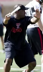Secondary coach Travaris "T-Rob" Robinson runs a drill during a position session.