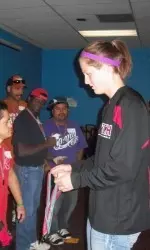 Cydney Allen presents a medal at the Special Olympics bowling event.