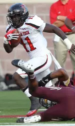 Texas Tech's Jakeem Grant works past Texas State's Xavier Daniels