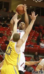 Jaye Crockett shoots over Northern Arizona forward Max Jacobsen.