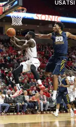 Devaugntah Williams (0) drives to the basket against West Virginia Mountaineers forward Brandon Watkins (20).