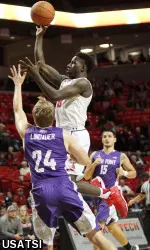 Devaugntah Williams shoots over High Point guard Anthony Lindauer.