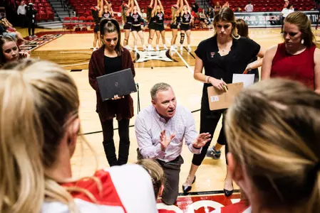 Coach Graystone huddle bench vs. Texas