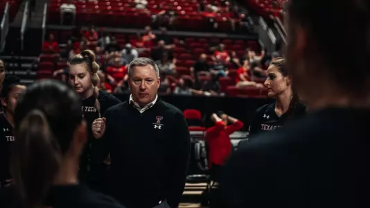Tony Graystone talks in huddle