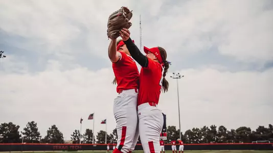 Erna Carlin and Page Mindedahl chest bump during lineups