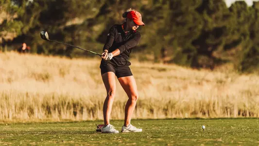 Kylee Loewe striking the golf ball