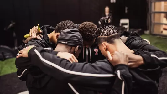 Men's track and field huddle