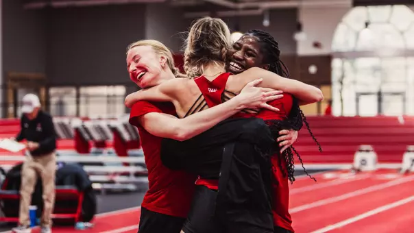 Evelynn Lavielle hugs her teammates Claire Lowrey and Temitope Adeshina