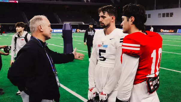 Texas Tech head coach Joey McGuire speaks to two of his former standouts in Cole Wisniewski (5) and Behren Morton (10) following practice for the East-West Shrine Bowl.