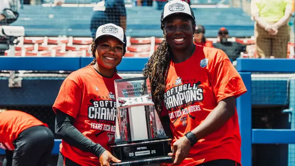 NiJaree Canady and Mihyia Davis holding the Big 12 tournament championship trophy