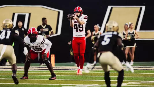 Will Karoll catches the ball as he prepares to punt in Texas Tech's win at Colorado.