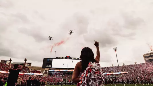 Two military helicopters fly over Galaxy Stadium at the end of the National Anthem prior to one of Texas Tech's 2025 home games.