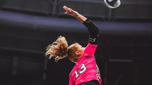 Shelby Ignash swinging her arm to attack a ball against TCU