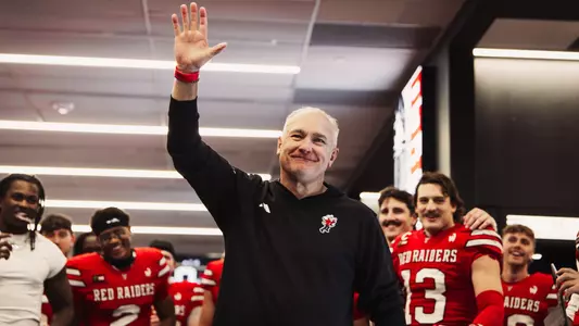 Joey McGuire raises his hand prior to addressing the Red Raiders in the locker room following Texas Tech's win over Arizona State.
