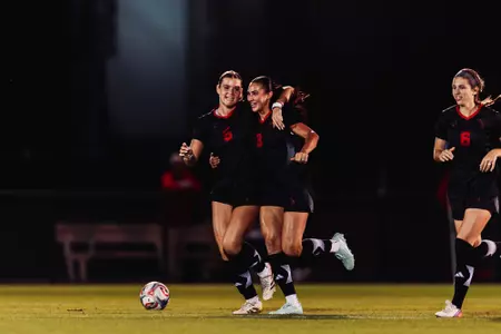 Kylie Bahr (3), Eleanor Hays (5) and Emilie McCartney (6) celebrate following Bahr's PK equalizer
