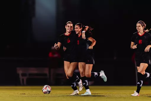Kylie Bahr (3), Eleanor Hays (5) and Emilie McCartney (6) celebrate following Bahr's PK equalizer