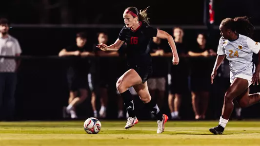 Taylor Zdrojewski dribbling the soccer ball ahead on a breakaway against West Virginia
