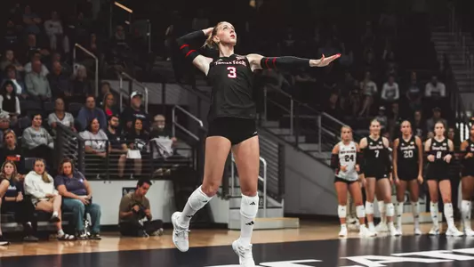 Aviya Russo jumping to serve a ball for Texas Tech volleyball against Kansas State