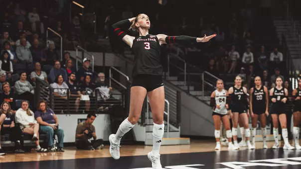Aviya Russo jumping to serve a ball for Texas Tech volleyball against Kansas State