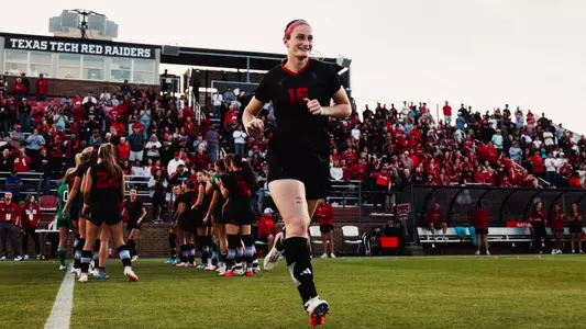Taylor Zdrojewski running onto the field as part of the starting lineup group