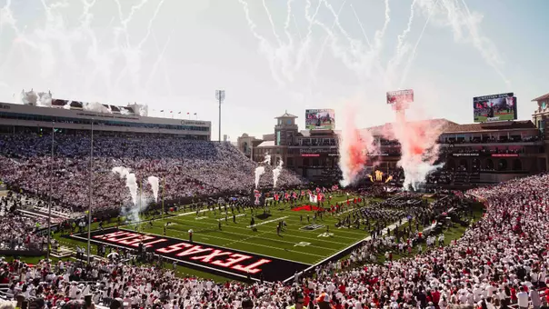 The Red Raiders enter the field behind the Masked Rider as fireworks and smoke go off in a sold out Galaxy Stadium.