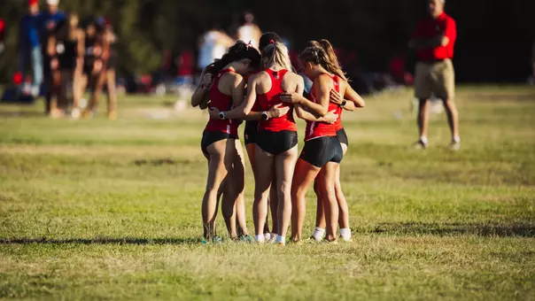 The women's cross country team huddled before running their race at the Texas Tech Open