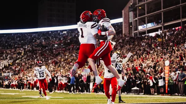 John Curry and Julien Laventure jump into each other to celebrate Curry's pick-six interception in Texas Tech's win at Colorado.