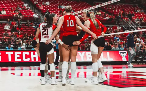 Red Raider volleyball team huddled up after a point